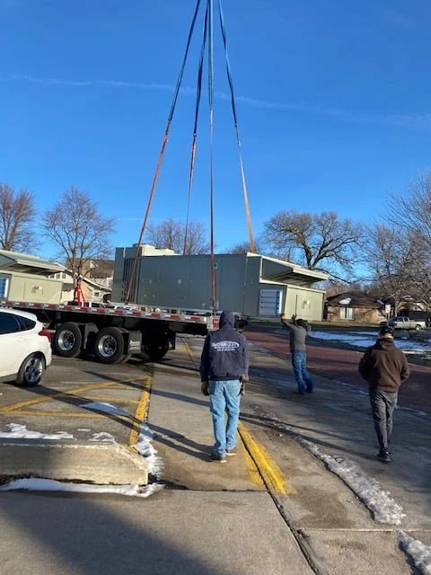A new air handler arriving by flatbed truck at the York City Auditorium