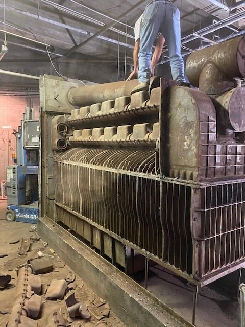 The old boiler opened up, cast-iron sections exposed, during demolition at the York City Auditorium