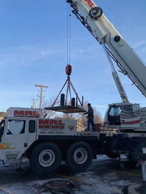 A McCormick’s crew guiding a unit as the crane lifts it at the York City Auditorium
