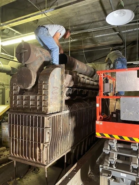 The original boiler being dismantled inside the York City Auditorium mechanical room