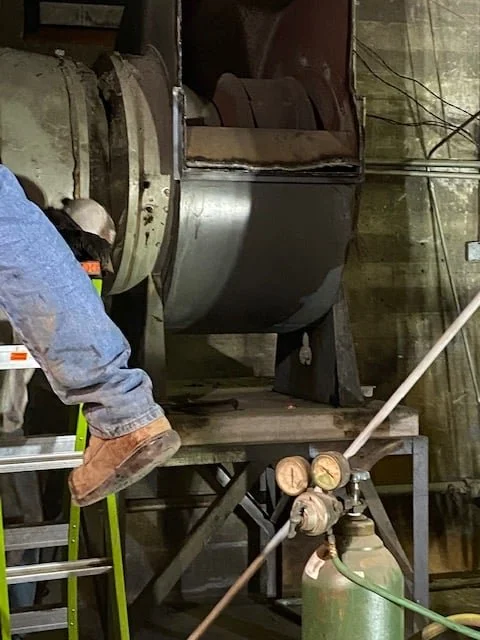 A technician working inside the auditorium’s original air plenum